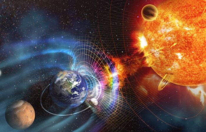 حلقات بيضاوية من طاقة زرقاء اللون تنطلق من كرة صفراء التي هي الشمس لتضرب سطح الكرة الأرضية وخلفه القمر