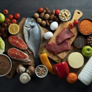 مجموعة من المأكولات كالسمك، الحليب، الليمون، التفاح، الفليفلة الصفراء والخس