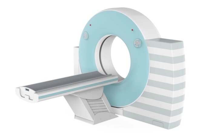 جهاز طبي اسطواني الشكل لونه سماوي في منتصفه فتحة يمر منها سرير طويل