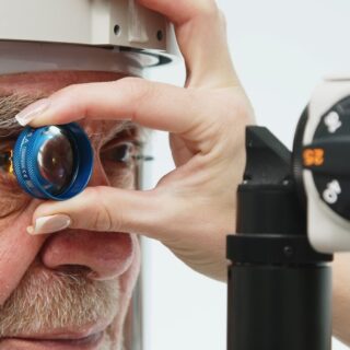 طبيب يقوم بفحص عيون رجل مسنّ